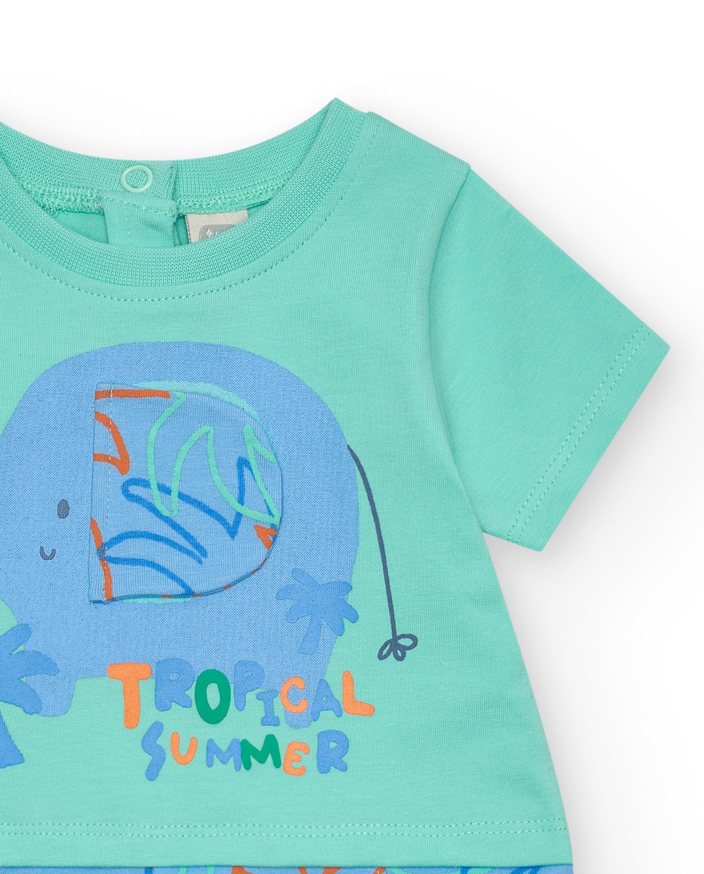 Children's romper with an elephant design and 'Tropical Summer' text on a light green background detail