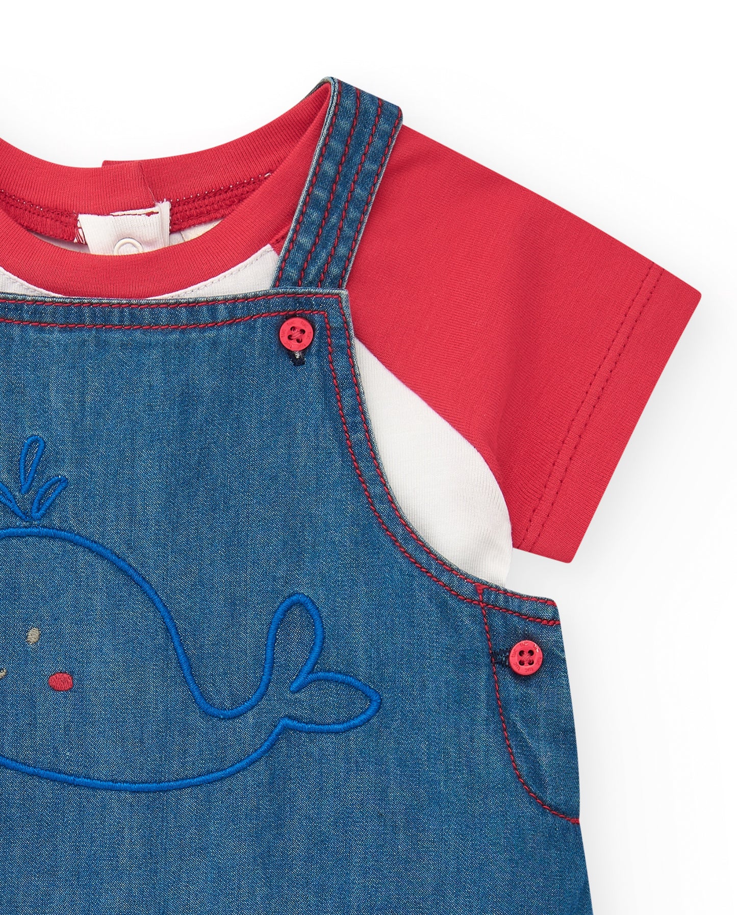 Red t-shirt with blue denim dungarees featuring a whale design on a white background